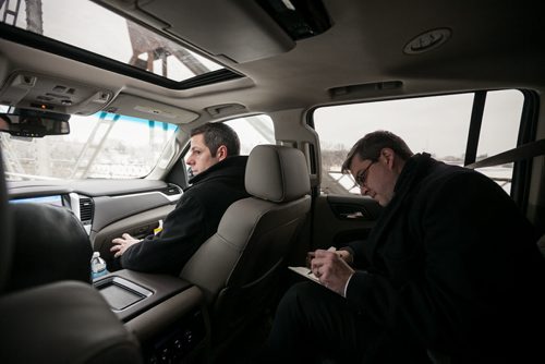 1:40:17 PM  The Mayor and chief of staff Jason Fuith inside the SUV on their way to Transcona. Fuith took notes on the tour, as the tour was meant to introduce the newbie Mayor and staff to projects in Transcona - a ward far from Bowman's home of Charleswood.  141215 - Monday, December 15, 2014 - (Melissa Tait / Winnipeg Free Press)