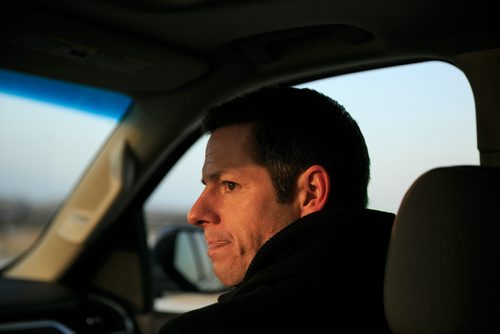 3:33:23 PM Late afternoon light on Bowman as the Transcona tour wraps up, and time is tight for his 4 p.m. meeting at the United Way offices for the End Homelessness initiative. 141215 - Monday, December 15, 2014 - (Melissa Tait / Winnipeg Free Press)