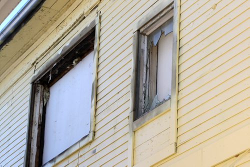 Jayson Donegan, Kristy Brisco and their 2 yr old  twin sons Zamder Donegan,green shirt, and Connor Donegan , not pictured, lost everything after their duplex, pictured, was engulfed in flames at 499 Pritchard Ave on Dec 04, 2014.. -These are boarded up windows on the second floor-Through the kindness of their friends, family and community, they have been slowly getting back on their feet.  -See Erin DeBooy story  Dec 29, 2014   (JOE BRYKSA / WINNIPEG FREE PRESS)