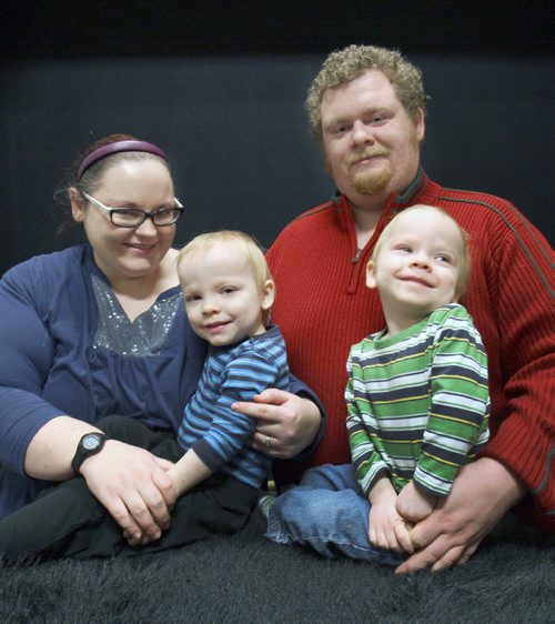 Jayson Donegan, Kristy Brisco and their 2 yr old  twin sons Zander Donegan,green shirt, and Conner Donegan - lost everything after their duplex was engulfed in flames at 499 Pritchard Ave on Dec 04, 2014.. Through the kindness of their friends, family and community, they have been slowly getting back on their feet.  -See Erin DeBooy story  Dec 29, 2014   (JOE BRYKSA / WINNIPEG FREE PRESS)