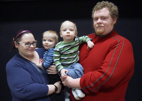 Jayson Donegan, Kristy Brisco and their 2 yr old  twin sons Zander Donegan,green shirt, and Conner Donegan - lost everything after their duplex was engulfed in flames at 499 Pritchard Ave on Dec 04, 2014.. Through the kindness of their friends, family and community, they have been slowly getting back on their feet.  -See Erin DeBooy story  Dec 29, 2014   (JOE BRYKSA / WINNIPEG FREE PRESS)