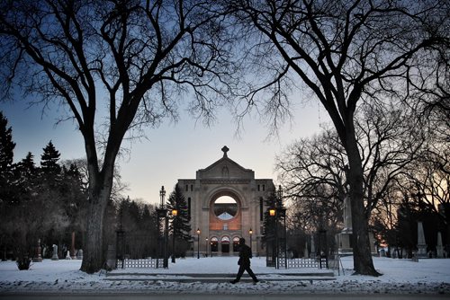 A pedestrian walks by the St. Boniface Cathedral early Tuesday morning as an extreme cold warning remains in effect.  141230 December 30, 2014 Mike Deal / Winnipeg Free Press