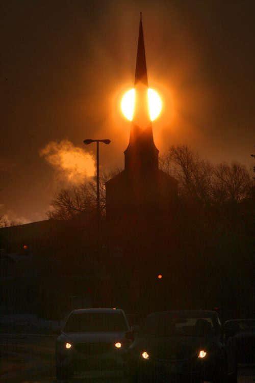 Chilly Sunrise- The sun rises Tuesday morning behind the Church of Christ  at 170 St Marys road in Winnipeg - Chilly winds and temperatures have seen Environment Canada to issue a Extreme Cold warning in effect-standup photo  Dec 30, 2014   (JOE BRYKSA / WINNIPEG FREE PRESS)