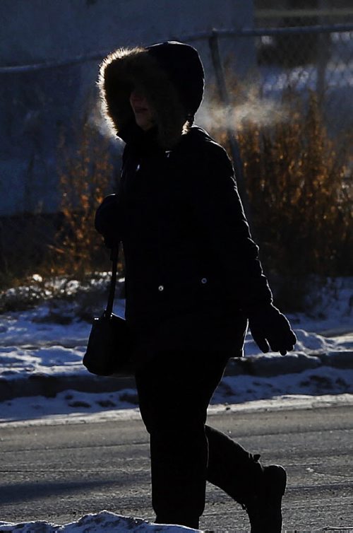 Stdup . -26 Cold Very Cold ,freezing breath  and bundled at pedestrian makes her way along  Sherbrook St. at  Cumberland Ave.  Dec. 30 2014 / KEN GIGLIOTTI / WINNIPEG FREE PRESS