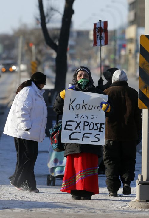 Stdup .A small group  of Opaskwayak Cree Nation were protesting the care of about 180 aboriginal children in care on Portage Ave and Maryland St in minus 23 degree cold . The small group is unhappy about kids being put in hotels and alleged poor monitoring . The started their protest Monday morning and will continue through the week .Kokum means grandmother . Dec. 30 2014 / KEN GIGLIOTTI / WINNIPEG FREE PRESS