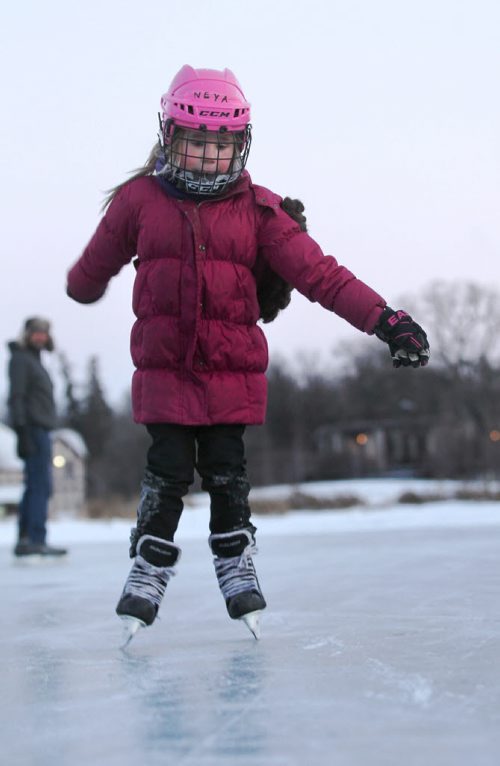 Six-year-old Neya Solmundson skates for the first time this winter on the Assiniboine Park Duck Pond as her dad Keith looks on Tuesday afternoon.     Dec 30, 2014 Ruth Bonneville / Winnipeg Free Press