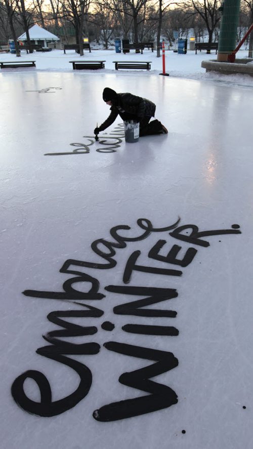 Local artist Kal Barteski begins painting New Years resolutions on the ice rink under the canopy at The Forks¤Wednesday morning.\¤Adam Wazny  story  Wayne Glowacki / Winnipeg Free Press Dec.31 2014