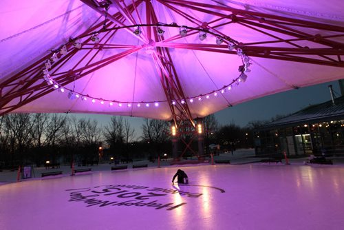 Local artist Kal Barteski begins painting her messages that will include New Years resolutions on the ice rink under the canopy at The Forks¤Wednesday morning.\¤Adam Wazny  story  Wayne Glowacki / Winnipeg Free Press Dec.31 2014