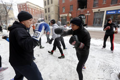 Stdup . Left Dylan Martin spars with Priyanka Dhillon  . Pan Am Boxing Club  , Boxers , Take it Outside with the First Annual Polar Boxing workout , something different for the 30 boxers at the Exchange club to do to mark the end of 2014 and the beginning of 2015. The one hour high intensity work took place with sparing , calisthenics , cycling and running .  Dec. 31 2014 / KEN GIGLIOTTI / WINNIPEG FREE PRESS