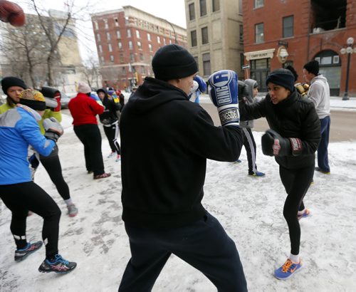 Stdup . left Dylan Martin spars with Priyanka Dhillon .Pan Am Boxers , Take it Outside with the First Annual Polar Boxing workout , something different for the 30 boxers at the Exchange club to do to mark the end of 2014 and the beginning of 2015. The one hour high intensity work took place with sparing , calisthenics , cycling and running .  Dec. 31 2014 / KEN GIGLIOTTI / WINNIPEG FREE PRESS