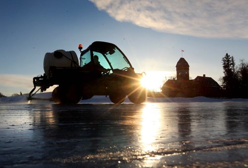 Assiniboine Park Grounds Keeper Bob Turcotte floods the Duck Pond Saturday morning as the sun peaks its head over the horizon for the first time in 2015 at the start of a new year.  Standup photo  Jan 01, 2015 Ruth Bonneville / Winnipeg Free Press