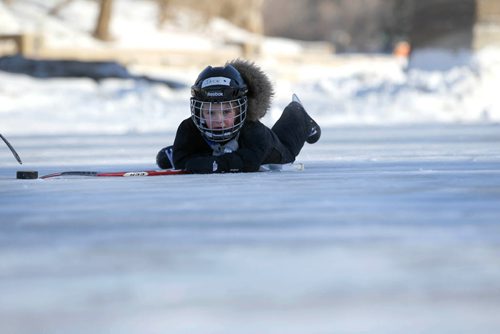 Four-year-old Jack Springer didn't seem to mind the cold even when he slips on the ice as he plays hockey with his dad on the new rink on the Assiniboine River Thursday.  Jan 01, 2015 Ruth Bonneville / Winnipeg Free Press