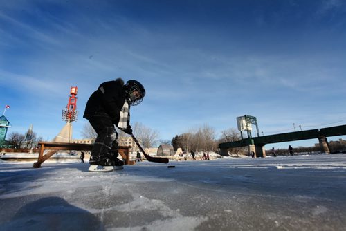 Four-year-old Jack Springer didn't seem to mind the cold as he plays hockey on the new rink on the Assiniboine River Thursday with his dad.    Jan 01, 2015 Ruth Bonneville / Winnipeg Free Press