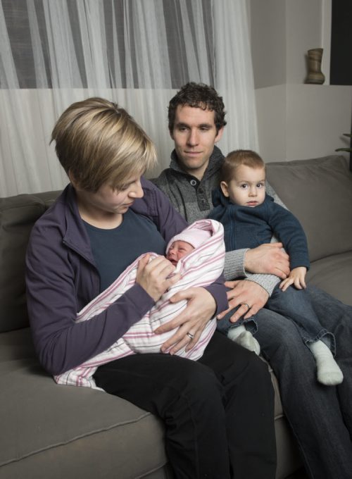 150101 Winnipeg - DAVID LIPNOWSKI / WINNIPEG FREE PRESS  Kris, Char, Aaron with new years baby Alaya Joy Kenemy at their home in Mitchell, Manitoba Thursday January 1, 2015. Char delivered Alaya with a home birth at 12:11AM in their living room.