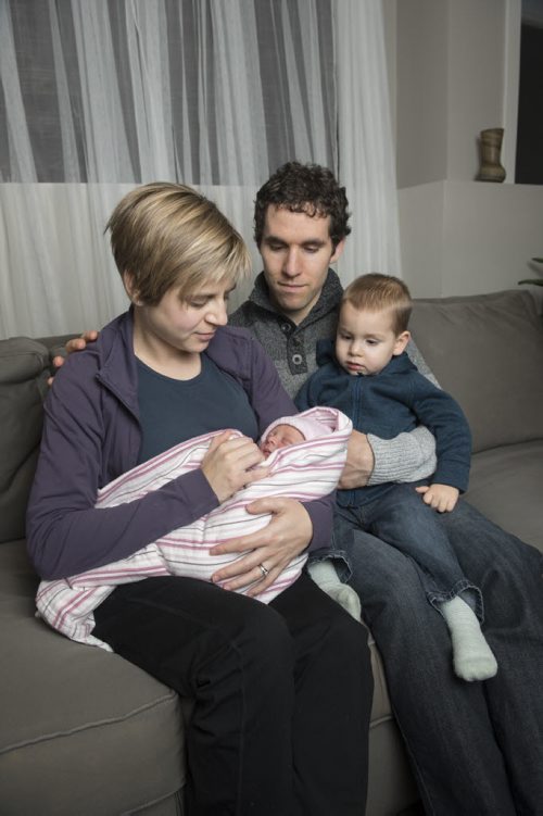 150101 Winnipeg - DAVID LIPNOWSKI / WINNIPEG FREE PRESS  Kris, Char, Aaron with new years baby Alaya Joy Kenemy at their home in Mitchell, Manitoba Thursday January 1, 2015. Char delivered Alaya with a home birth at 12:11AM in their living room.
