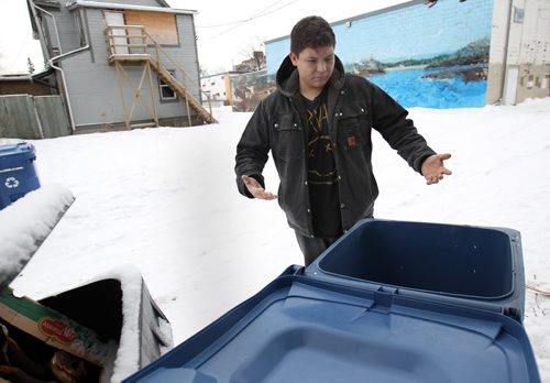Robert (JD) Keno, 20 years stands by the recycling bin and shows where he found lifted a 19 month old female baby left abandoned early this AM in a recycling bin in a rear lane of Pritchard Ave -See Jesse Winter story Jan 02, 2015   (JOE BRYKSA / WINNIPEG FREE PRESS)