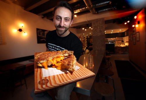 King + Bannaytne's Mike Del Buono shows off this week's srilled cheese, the "Apple Pie" at the eatery located at the intersection of it's name. This is for an Intersection piece on gourmet grilled cheese sandwiches. I went around town looking for some of the best/most unique & heres what I came up with. (Well need vertical pics of at least one locale  not sure how many pics we want to run along  with story) January 5, 2015 - (Phil Hossack / Winnipeg Free Press)