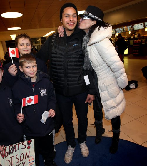 Team Canada Jr Hockey star Madison Bowey posed with members of the Starbuck Hockey Acadamy, his old school,  while an impatient mom Pam, snuck in from behind for a kiss Tuesday afternoon at Richardson Airfield Tuesday afternoon. See Melissa Martin's story. January 6, 2015 - (Phil Hossack / Winnipeg Free Press)