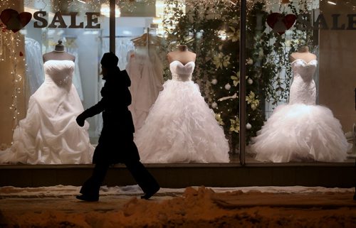 A woman looks at a display of wedding dresses on Portage Avenue, Wendesday, January 7, 2015. (TREVOR HAGAN/WINNIPEG FREE PRESS)