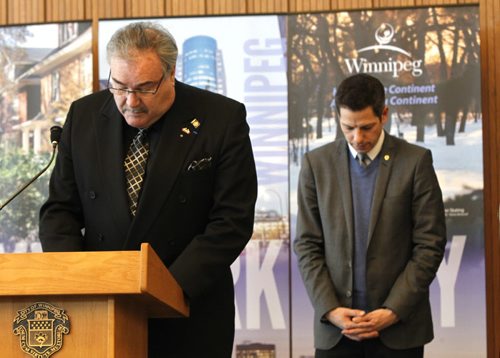 Winnipeg Mayor Brian Bowman at right and Bruno Burnichon, Honourary Counsul for France in Winnipeg and members of Council took part in a vigil to offer condolences to the victims and their families after the tragic events in France. Geoff Kirbyson story. Wayne Glowacki/Winnipeg Free Press Jan. 8 2015