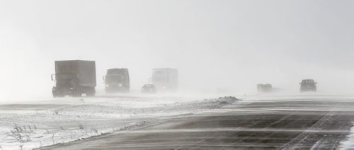 Traffic moves in from and in to a wall of blowing snow at the top of an overpass on One Canada Way Thursday afternoon. Blowing snow was the cause of at least one accident between two tractor trailers and a pickup between Portage and Headingly on the Trans Canada before the section of highway was closed to traffic due to poor conditions. January 8, 2015 - (Phil Hossack / Winnipeg Free Press)