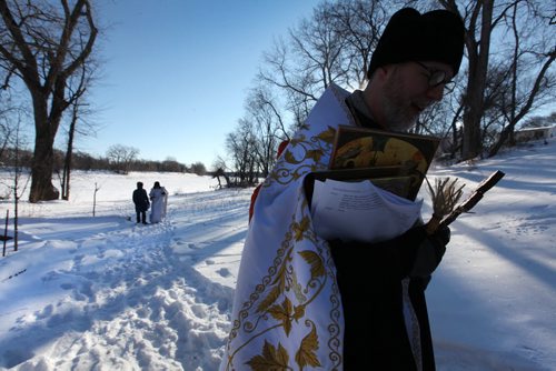 Father Gregory Scratch (white beard), Deacon  Matthew Beynon and members of St. Nicholas Orthodox Church,  stepped out onto the frozen Red River near Burrows Ave. for the Great Blessing of Waters held on the feast of Theophany or Epiphany Saturday.  See Kevin Rollason's story.  Jan 10, 2015 Ruth Bonneville / Winnipeg Free Press