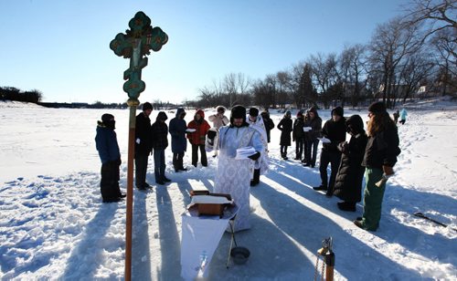 Father Gregory Scratch (white beard), Deacon  Matthew Beynon and members of St. Nicholas Orthodox Church,  stepped out onto the frozen Red River near Burrows Ave. for the Great Blessing of Waters held on the feast of Theophany or Epiphany Saturday.  See Kevin Rollason's story.  Jan 10, 2015 Ruth Bonneville / Winnipeg Free Press