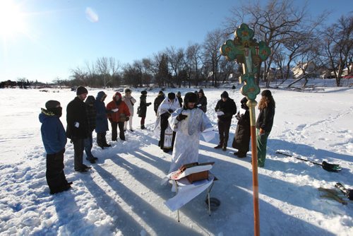 Father Gregory Scratch (white beard), Deacon  Matthew Beynon and members of St. Nicholas Orthodox Church,  stepped out onto the frozen Red River near Burrows Ave. for the Great Blessing of Waters held on the feast of Theophany or Epiphany Saturday.  See Kevin Rollason's story.  Jan 10, 2015 Ruth Bonneville / Winnipeg Free Press
