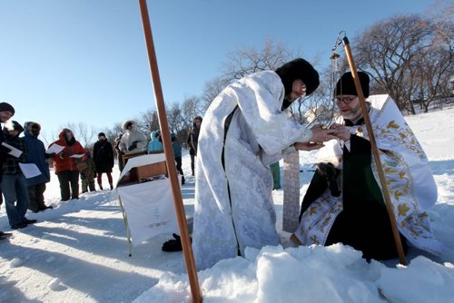 Father Gregory Scratch (white beard), Deacon  Matthew Beynon and members of St. Nicholas Orthodox Church,  stepped out onto the frozen Red River near Burrows Ave. for the Great Blessing of Waters held on the feast of Theophany or Epiphany Saturday.  See Kevin Rollason's story.  Jan 10, 2015 Ruth Bonneville / Winnipeg Free Press