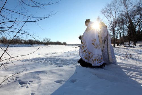 Father Gregory Scratch (Left with Cape, white beard), Deacon  Matthew Beynon and members of St. Nicholas Orthodox Church,  stepped out onto the frozen Red River near Burrows Ave. for the Great Blessing of Waters held on the feast of Theophany or Epiphany Saturday.  See Kevin Rollason's story.  Jan 10, 2015 Ruth Bonneville / Winnipeg Free Press