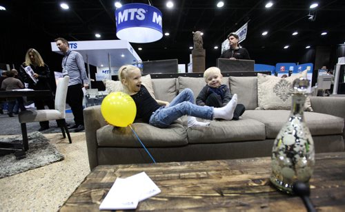 Three-year-old Andrew Carlson checks out the softness of a pillow and couch with his sister Jocelyn - 6-years, at the Wicker World Display  while attending the Kitchen & Bath Show at the Convention Centre with family Saturday.   Standup photo Jan 10, 2015 Ruth Bonneville / Winnipeg Free Press