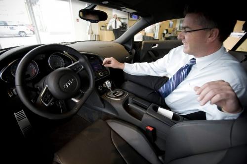 John Woods / Winnipeg Free Press / September 12/07- 070912  - Salesman Brian Baker plays with the dials in the new 2008 Audi R8 inside the St. James Volkswagen/Audi dealership Wednesday September 12/07.