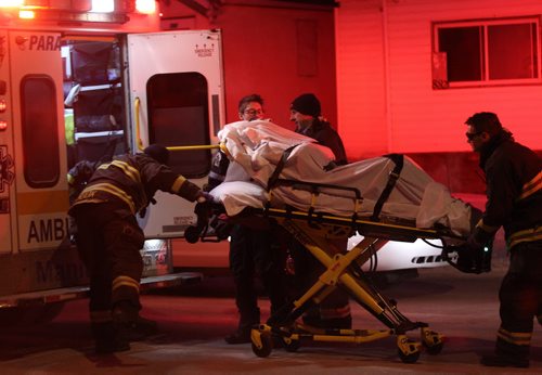 Police and Fire and Paramedics remove a person who was thought to have been stabbed in the 800 block of Mountain Ave near 730 AM this morning Breaking News- Jan 12, 2015   (JOE BRYKSA / WINNIPEG FREE PRESS)