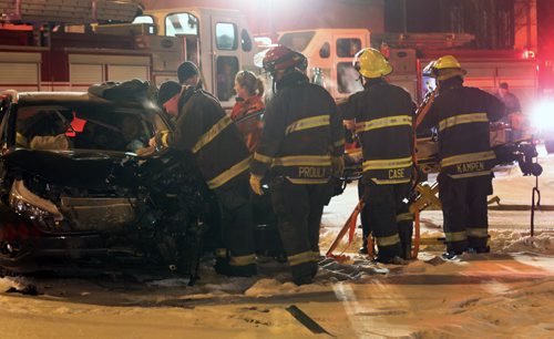 Mvc at Broadway and Smith St - fire and paramedics prepare to remove patient from vehicle to transport to hospital- Broadway traffic is closed in both directions as crews work- Jan 13, 2015   (JOE BRYKSA / WINNIPEG FREE PRESS)