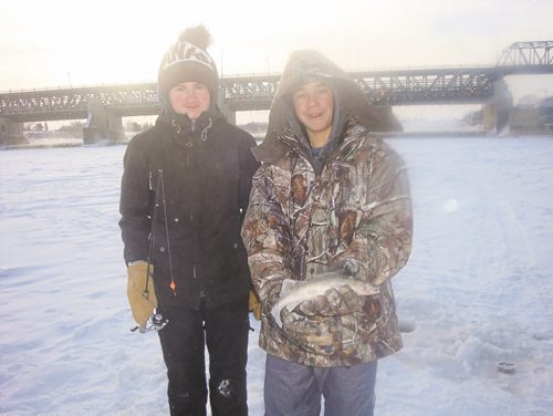 Canstar Community News Jan. 8, 2015 - Will Hartfiel and Hudson Wall of River East Collegiate show off a sauger they caught on an outdoor education ice fishing trip to Lockport, MB. (Photo supplied by Martin Grubert)