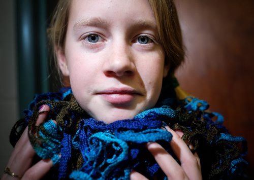Avrey Murdy, 11 shows off a fancy scarf she knitted in class. Elaine Owen, a teacher at Miami School in Miami, Manitoba has undertaken a huge project to teach her students some core values. Over the last six months, she has gathered raw wool and shown her students the process through washing, carding, dyeing and spinning the wool and then using looms, making mittens, scarves, etc. Elaine has four spinning wheels in her classroom and the students are donating their crafted items to a local shelter.  150113 - Wednesday, January 14, 2015 -  (MIKE DEAL / WINNIPEG FREE PRESS)