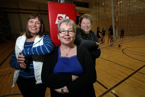 Left to right Joan Chaput, Donna Dawson and Sharon Martin pose on the court as the current Bison Women's team works out Wednesday. The trio played on the 1970-71 Bisonette team that won the first official Canadian Championship. See Melissa Martin's story. January 14, 2015 - (Phil Hossack / Winnipeg Free Press)