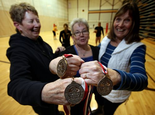 Showing off the historic hardware, (left to right) Sharon Martin, Donna Dawson,  and Joan Chaput recall their days with the University of Manitoba Bisonettes womens volleyball team that won the first ever official Canadian national championship. See Melissa Martin's story. January 14, 2015 - (Phil Hossack / Winnipeg Free Press)