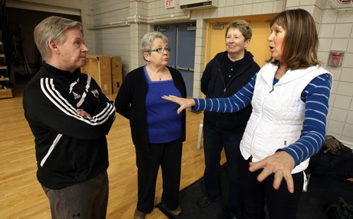U of M Women's Volleyball coach Ken Bentley listens intently as (left to right) Donna Dawson, Sharon Martin, and Joan Chaput recall their days with the University of Manitoba Bisonettes womens volleyball team that won the first ever official Canadian national championship. See Melissa Martin's story. January 14, 2015 - (Phil Hossack / Winnipeg Free Press)