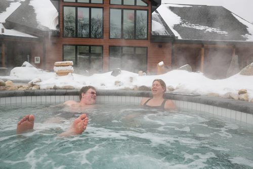 Doug Speirs and Nordik Spa-Nature spokesperson Marianne Trottier in the outdoor hot tub during a quick test run of the thermotherapy (or heat therapy) offered at the brand new Thermea spa on Crescent Drive. After spending time in a dry sauna, clients quickly walk through an ice-cold pool to shock the system, before relaxing in the hot tub, sauna or other relaxation areas.     January 15, 2015 (Melissa Tait / Winnipeg Free Press)
