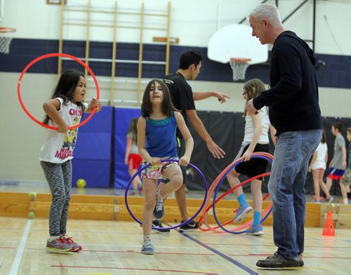 Windsor School grade 3 students Kaleigh Smith and Donya Naghibzad work with Dean Kriellaars, a University of Manitoba exercise physiologist who also works with Cirque de Soleil performers. He is working on a preliminary study with a Montreal-based researcher from the National Circus School. He is at Windsor School to find out how kids respond to creative circus-inspired movement. BORIS MINKEVICH/WINNIPEG FREE PRESS. JANUARY 15, 2015