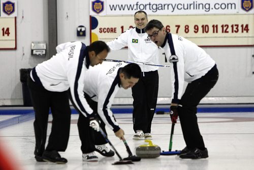 A team from Brazil skipped by Marcelo Mello (second from right) is competing in the Manitoba Open Bonspiel. The team (l-r) Filipe Nunes, Sergio Vilela, skip Marcelo Mello and Raphael Monticello took part in the opening ceremonies and threw the ceremonial first rock to kick off the Bonspiel at the Fort Garry Curling Club Thursday evening.  150115 January 15, 2015 Mike Deal / Winnipeg Free Press
