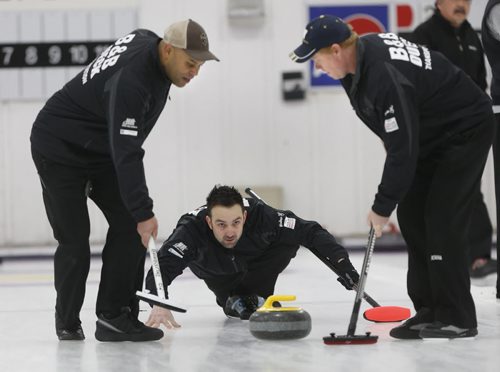 Skip Kevin Brown throws a rock with team mates lead Stan Pierre at left and second Craig Nichol in a game at the Assiniboine Memorial CC Friday.  Ed Tait story  Wayne Glowacki / Winnipeg Free Press ¤Jan. 16 2015