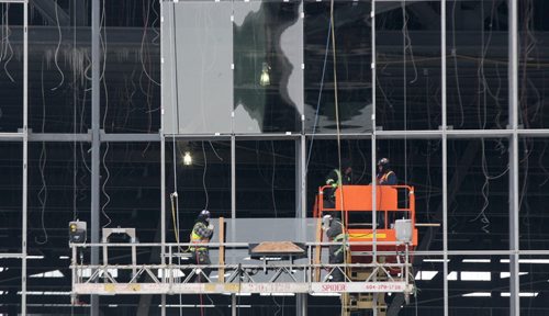 Workers move glass panels in place at the RBC Convention Centre expansion in downtown Winnipeg-The 180 Million dollar expansion will add almost double space to the Convention Centre-Standup Photo- Jan 16, 2015   (JOE BRYKSA / WINNIPEG FREE PRESS)