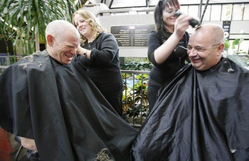 John Woods / Winnipeg Free Press / September 14/07- 070914  - Royal Canadian Mint employees Ray Steen (L) and Peter Gsols get their heads shaved by Amy Wilford (L) and Suzi Harder of MC College for the Terry Fox Foundation's Great Canadian Head Shave on  Friday September 14/07 at the Mint.  The Foundation expects to raise over $100000.