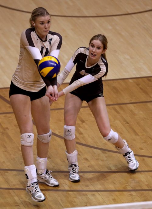 University of Manitoba Bisons' Tori Studler and Caleigh Dobie both try to receive a serve by the Alberta Pandas during volleyball action at the U of M, Friday, January 16, 2015. (TREVOR HAGAN/WINNIPEG FREE PRESS)