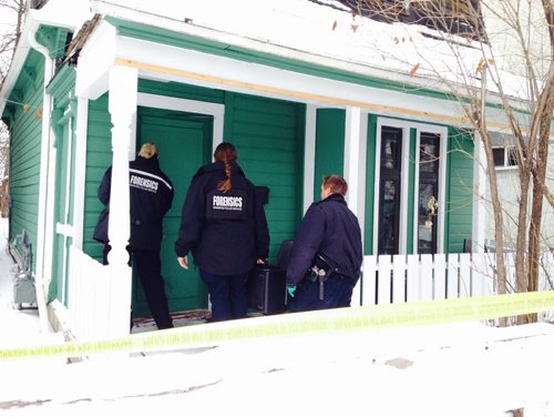 A forensic team makes their way into 101 Lorne Ave. Saturday afternoon to further investigate the death of a female from an altercation that occurred in the early morning hours.   Jan 17/2014  Ruth Bonneville / Winnipeg Free Press.