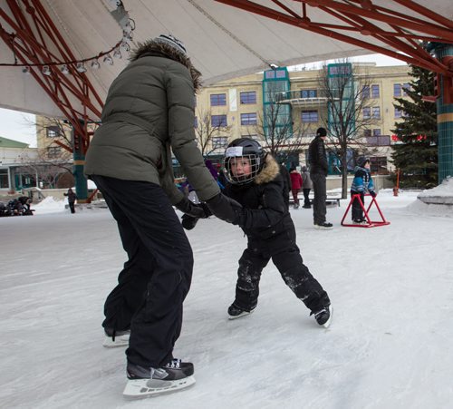 Brandee Olafson and her son Blake, 5, go for a skate under the canopy at The Forks. Hundreds took advantage of the slightly warmer weather and headed to The Forks for the kick-off of its winter adventure programming. 150118 - Sunday, January 18, 2015 -  (MIKE DEAL / WINNIPEG FREE PRESS)