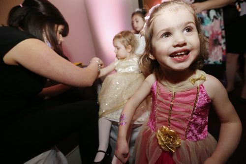 January 18, 2015 - 150118  -  Sonja Kuhl (2) shows off her glitter tattoo as her cousin Luzy Enns (3) gets one at the first annual Royal Princess Ball in support of The Children's Hospital Foundation of Manitoba at the Viscount Gort Hotel Sunday, January 18, 2015. John Woods / Winnipeg Free Press