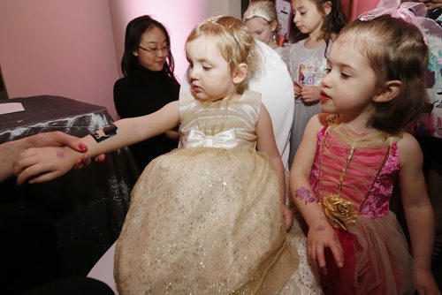 January 18, 2015 - 150118  -  Luzy Enns (3) and her cousins Sonja Kuhl (2) get some glitter tattoos at the first annual Royal Princess Ball in support of The Children's Hospital Foundation of Manitoba at the Viscount Gort Hotel Sunday, January 18, 2015. John Woods / Winnipeg Free Press